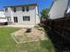 Landscaped backyard with fire pit and green lawn, perfect for outdoor activities and relaxation at 20558 E Grand Ln, Aurora, CO 80015