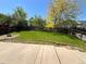 Picturesque backyard with green grass, patio, and shade trees is ready for your imagination at 20558 E Grand Ln, Aurora, CO 80015