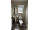 Updated half bath featuring a pedestal sink, new toilet, and modern flooring at 20558 E Grand Ln, Aurora, CO 80015
