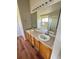 Bathroom with double sinks, wood cabinets, and a large mirror at 20558 E Grand Ln, Aurora, CO 80015