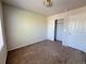Neutrally painted bedroom featuring carpet flooring and double door closets at 20558 E Grand Ln, Aurora, CO 80015