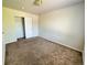 Neutrally painted bedroom featuring carpet flooring and double door closet for storage at 20558 E Grand Ln, Aurora, CO 80015
