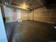 Spacious two car garage featuring a utility door for access to outside, and a concrete floor at 20558 E Grand Ln, Aurora, CO 80015