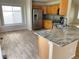 Well-lit kitchen with stone countertops, stainless steel appliances, and tile flooring at 20558 E Grand Ln, Aurora, CO 80015