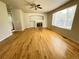 Open living room with hardwood floors, ceiling fan, and a cozy fireplace at 20558 E Grand Ln, Aurora, CO 80015