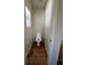 A small bathroom featuring wood floors and a window at 20558 E Grand Ln, Aurora, CO 80015