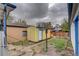 Backyard featuring a yellow shed, minimal lawn space and greenery, with access steps at 4514 Bryant St, Denver, CO 80211