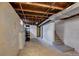 Unfinished basement with concrete walls and floors, exposed wood ceiling and utilities at 4514 Bryant St, Denver, CO 80211