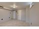 Unfinished basement with neutral paint, tile flooring, doors and overhead lighting at 4514 Bryant St, Denver, CO 80211