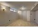 Finished basement area with paneled walls and neutral tile floor at 4514 Bryant St, Denver, CO 80211
