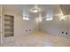 Spacious basement featuring tile flooring, built in shelving and two window views at 4514 Bryant St, Denver, CO 80211