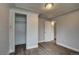 Bedroom featuring hardwood flooring, neutral walls, closet, and arched doorway at 4514 Bryant St, Denver, CO 80211