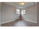 Bedroom with two windows and hardwood flooring, offering a bright and airy space at 4514 Bryant St, Denver, CO 80211