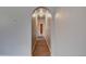 Hallway featuring laminate flooring and an arched entrance, highlighting the home's architectural details at 4514 Bryant St, Denver, CO 80211