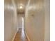 Narrow hallway with textured walls and wood-look flooring at 4514 Bryant St, Denver, CO 80211
