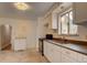 Bright kitchen features white cabinets, tile floor, and stainless steel stove at 4514 Bryant St, Denver, CO 80211