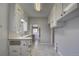 Galley kitchen featuring white cabinets, tile flooring, and a view into the next room at 4514 Bryant St, Denver, CO 80211