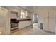 Bright kitchen features white cabinets, tile floor, and stainless steel stove at 4514 Bryant St, Denver, CO 80211