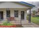 Inviting front porch with wrought iron railing, comfortable seating, and a charming welcome mat at 4514 Bryant St, Denver, CO 80211