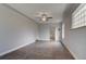 Open room featuring a ceiling fan and views to the kitchen, completed with laminate wood flooring at 4514 Bryant St, Denver, CO 80211