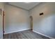 Minimalist room showcasing smooth gray walls, laminate wood flooring, and neutral decor at 4514 Bryant St, Denver, CO 80211