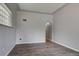 Neutral room highlighting an air vent and gray walls, complemented by laminate wood flooring at 4514 Bryant St, Denver, CO 80211