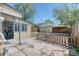 Cozy backyard with stone patio, privacy fence, garden bed and access to a screened-in back porch seating area at 2684 S Logan St, Denver, CO 80210