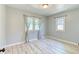Light and airy bedroom with vinyl floors and two windows offering views of the neighborhood at 2684 S Logan St, Denver, CO 80210