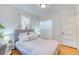 Comfortable bedroom featuring wood floors, soft lighting, a closet, and neutral decor at 2684 S Logan St, Denver, CO 80210