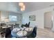 Open dining area with table setting, flowing into the living room for easy entertaining at 2684 S Logan St, Denver, CO 80210
