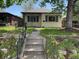 Charming home with manicured front yard, walkway steps and mature landscaping for a welcoming entrance at 2684 S Logan St, Denver, CO 80210