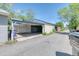 View of a 2-car detached garage from the alley with covered carport at 2684 S Logan St, Denver, CO 80210