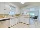 Bright kitchen featuring white cabinets, modern appliances, and a breakfast bar at 2684 S Logan St, Denver, CO 80210