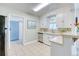 Functional kitchen with white cabinetry, stainless steel appliances, and tile flooring at 2684 S Logan St, Denver, CO 80210