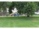 Green grass and play equipment can be seen at Harvard Gulch Park at 2684 S Logan St, Denver, CO 80210