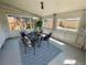 Sun room with a rug, large windows and a sitting area with a table and four chairs at 2684 S Logan St, Denver, CO 80210