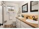 Bright bathroom with double vanity, decorative mirrors, and stylish tile flooring at 7256 S Broadway, Centennial, CO 80122