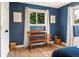 Bedroom featuring blue walls, wood floors, and ample light from the windows at 7256 S Broadway, Centennial, CO 80122