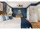 Comfortable bedroom showcasing a stylish wooden dresser and decorative touches with ample lighting at 7256 S Broadway, Centennial, CO 80122