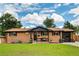 Charming brick home with a manicured lawn and inviting front porch at 7256 S Broadway, Centennial, CO 80122