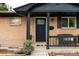 Inviting front entry with decorative door and black trim at 7256 S Broadway, Centennial, CO 80122