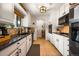Updated kitchen with white cabinets, granite counters, stainless appliances, and tile backsplash at 7256 S Broadway, Centennial, CO 80122