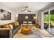 Bright living room with sliding glass door, modern decor, and hardwood floors at 7256 S Broadway, Centennial, CO 80122