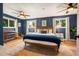Serene main bedroom with blue walls, natural light, and a cozy rug, creating a peaceful retreat at 7256 S Broadway, Centennial, CO 80122