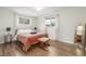 Bright bedroom with hardwood floors, a stool, and sheer curtains at 3465 E Arapahoe Pl, Centennial, CO 80122