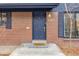 Charming brick home with a blue door with the house number at 3465 E Arapahoe Pl, Centennial, CO 80122