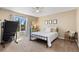 Cozy bedroom with ceiling fan, a treadmill and bright window with backyard view at 139 N Prairie Falcon Pkwy, Brighton, CO 80601