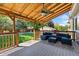 Outdoor deck boasts comfortable seating, a ceiling fan, and wood supports at 139 N Prairie Falcon Pkwy, Brighton, CO 80601