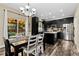 Open dining area with dark wood table, stainless steel appliances, and sliding door access to backyard at 139 N Prairie Falcon Pkwy, Brighton, CO 80601