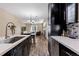 Open layout featuring stainless appliances, dark wood cabinets, and seamless transition to living and dining area at 139 N Prairie Falcon Pkwy, Brighton, CO 80601